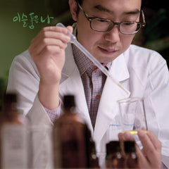 Person in a lab coat holding a test tube with a blurred background