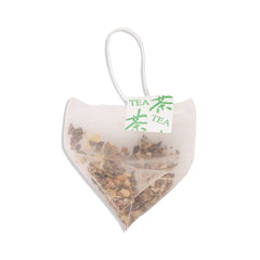 Heart-shaped tea bag with bitter mellon tea and 'TEA' label on a white background