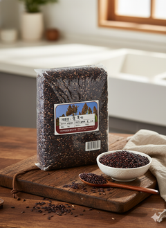 Packaged black rice on a wooden cutting board with a bowl of black rice and a spoon.