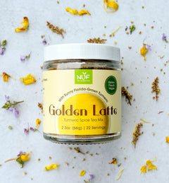 Jar of NUF Golden Latte Turmeric Spice Tea Mix on a light background with flowers.
