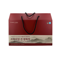 Red gift box with black handle and mountain design on a white background
