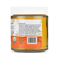 Jar of organic turmeric powder with label on a white background