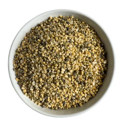 White bowl filled with a mixture of yellow and green mung beans on a white background