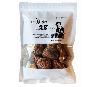 Packaged dried shitaki mushrooms with a white label on a white background